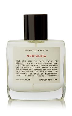 a bottle of perfume that is on a white surface with the words nostalia written in