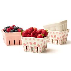 three bowls with strawberries, blueberries and raspberries in them on a white background