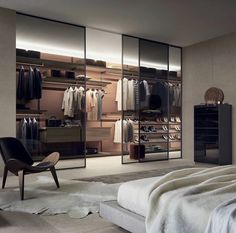 a bedroom with a bed, chair and closets in it's center area