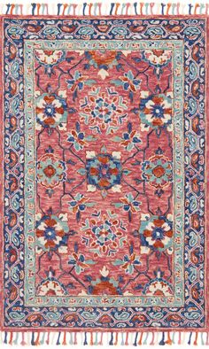 a red and blue rug with fringes on the bottom, in an ornate pattern