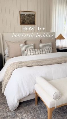 a white bed sitting in a bedroom next to a window with the words how to hotel style bedding on it