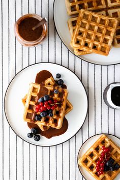waffles with syrup and berries on plates