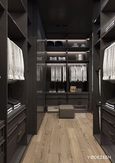a walk in closet with lots of white shirts and pants on the shelves next to it