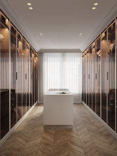 an empty dressing room with mirrored doors on the walls and wooden flooring in front of it