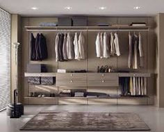 a walk in closet filled with lots of clothes and drawers next to a rug on the floor