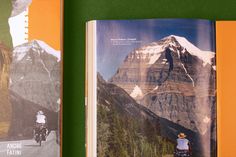 an open book with pictures of mountains and people riding bikes on the road in front of it
