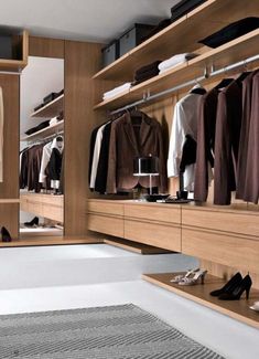 a walk in closet filled with lots of clothes
