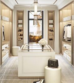 a large walk in closet with shoes and handbags on the floor next to it