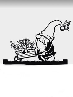 a black and white image of a gnome pushing a wagon with flowers