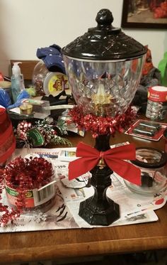 a table topped with lots of clutter and dishes covered in red ribboned bows