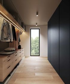 an open closet with clothes hanging on the wall and doors to another room in front of it