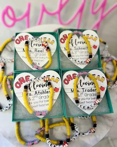 four heart - shaped bracelets are on display in a box with the words, one is