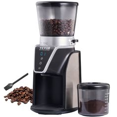 an image of a coffee grinder with beans on the side and a blender next to it