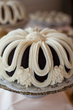 a bundt cake with white frosting on a plate