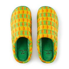 a pair of yellow and green slippers sitting on top of each other