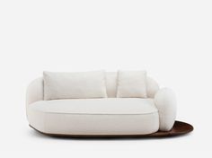 a white couch sitting on top of a wooden table