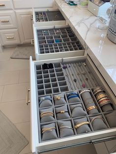 the drawers are filled with jewelry and bracelets