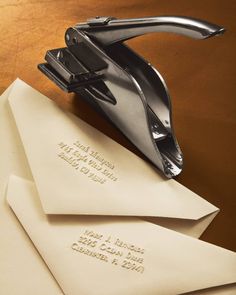 three envelopes are stacked on top of each other with a stapler attached to them