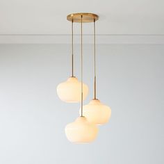 three lights hanging from a ceiling in a room