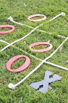 an outdoor game set up in the grass with letters and numbers painted on it's sides