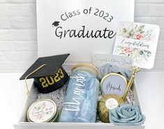 a graduation gift box filled with congratulations items