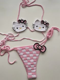 two hello kitty bikinis are shown on a white surface with pink and white polka dots