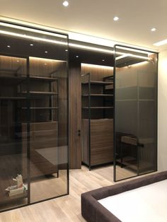 an empty room with glass doors and shelves