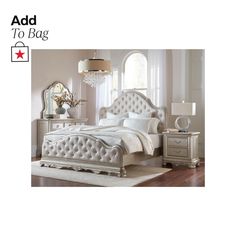 a white bed sitting on top of a wooden floor next to a dresser and mirror