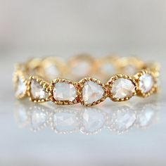 an image of a gold ring with white stones