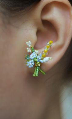a close up of a person's ear with flowers on it