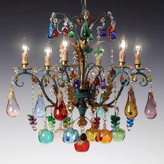 a chandelier with many different colored glass pieces hanging from it's arms