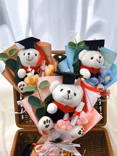 a teddy bear arrangement in a basket with flowers and graduation caps on it's head