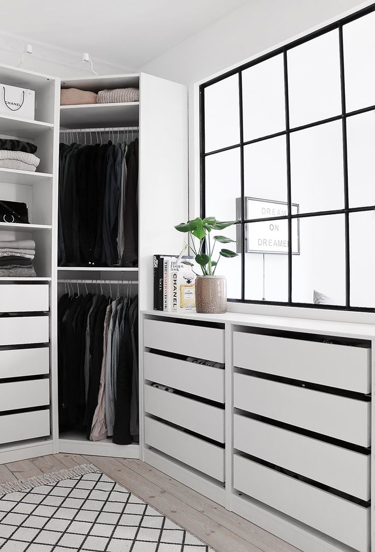 a white closet filled with lots of clothes