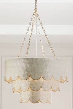 a chandelier hanging from a ceiling in a room with white walls and ceilings