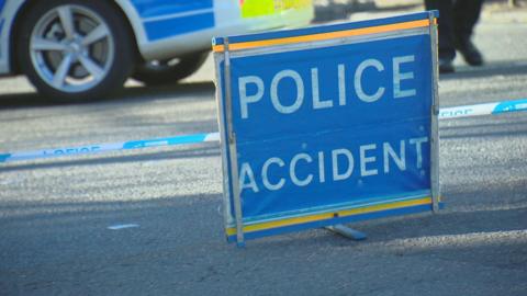 Generic image - Police accident sign on a road with police car in background