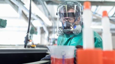 Man preparing chemicals in factory