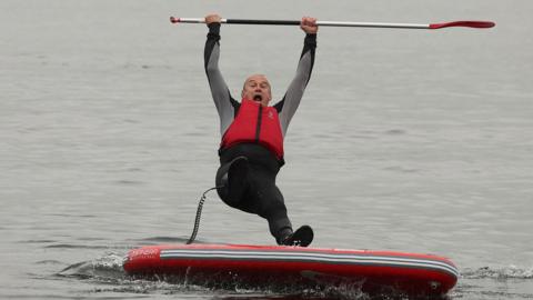 Ed Davey falls from a paddle board