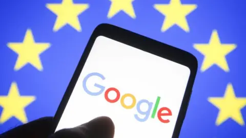 Getty Images Smartphone screen displays Google logo against backdrop of EU flag