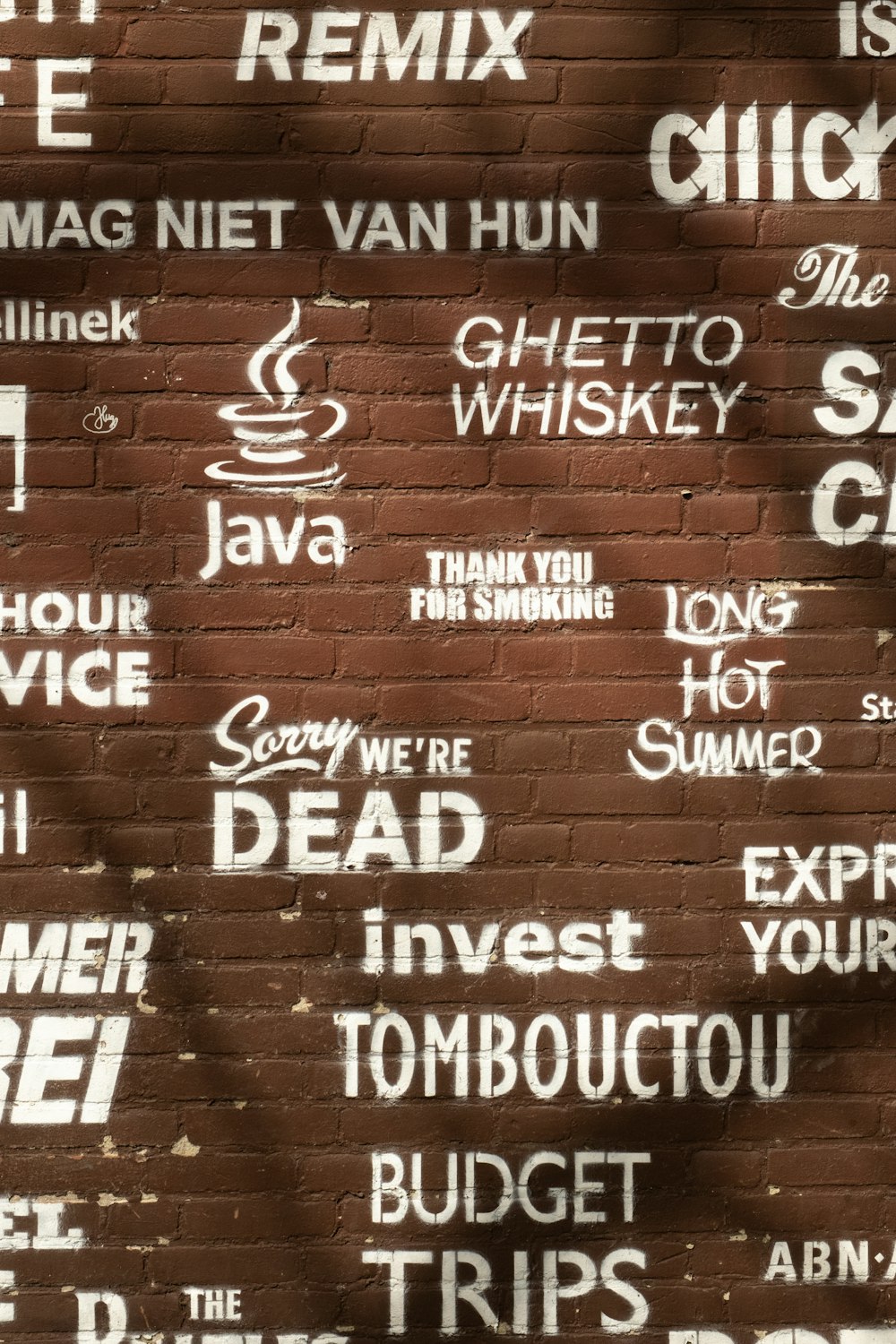 a brick wall with graffiti written on it