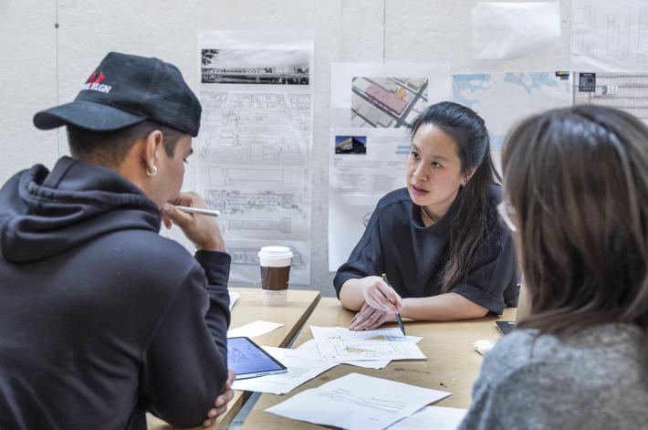Ann Lui discusses a project with a student in her senior design studio