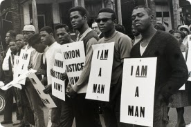 Photograph of Black protesters at the Justice March, holding "I am a man" signs.