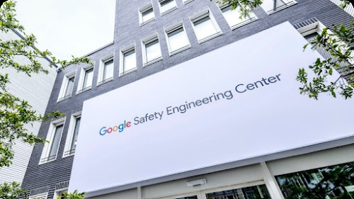 A Google Safety Engineering Centre (GSEC) billboard outside a skyscraper.