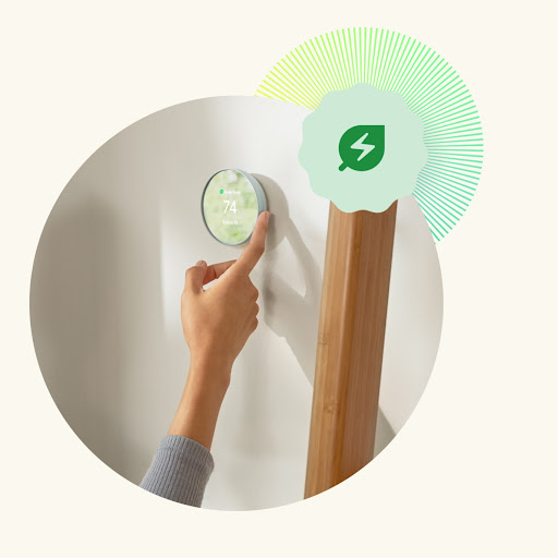 Close-up of a hand adjusting the temperature on a Nest Thermostat