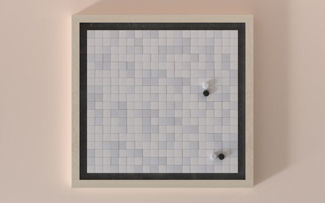 A Go board – a gridded board with unmarked black and white stones set down on it.