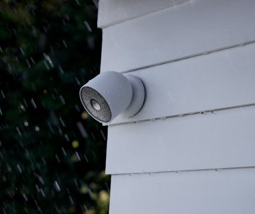 Nest Cam installed on outdoor wall in the rain.