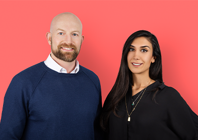 Cofounders Peter Fish and Shardi Nahavandi smile at a camera against a pink backdrop.