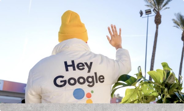 Photo of the back of a staff uniform jacket that reads: Hey Google.
