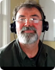 Image of a spectacled man with headphones
