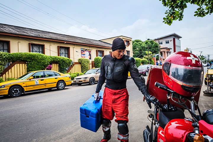 Joseph Kalu, a LifeBank driver, carrying blood is in his cold chain transport box.