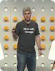 Man on stage wearing Hire with Google tee shir
